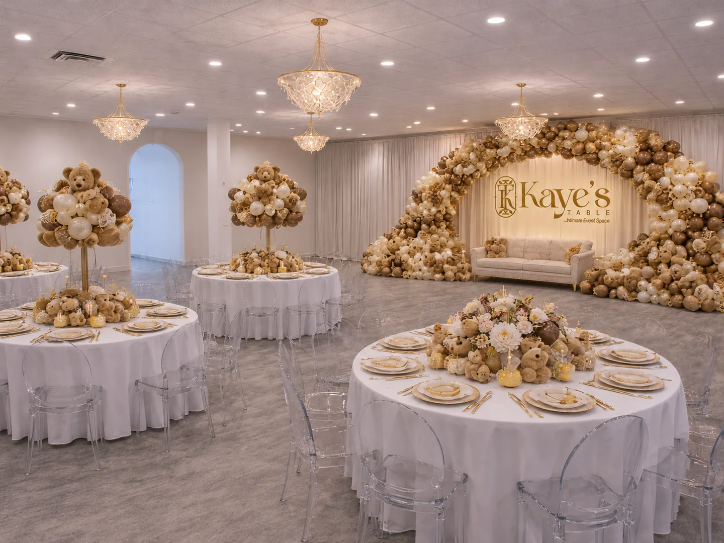 Round tables beneath chandeliers and a champagne-toned balloon installation at Kaye’s Table.